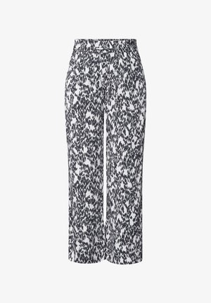 Mustat ja valkoiset kuvioidut lyhyet housut, joissa on pehmeä rakenne, joustava vyötärö ja koristeellinen metallikoriste vyötäröllä.