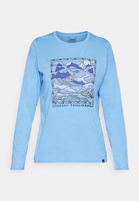 Light blue long-sleeve t-shirt featuring a colorful mountain landscape graphic in purple and blue with "Patagonia Trailseekers" text below.