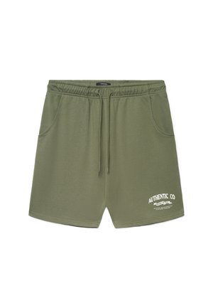 Pantaloncini in cotone verde oliva con cintura elastica e coulisse. Presentano due tasche laterali e dettaglio logo stampato bianco sul davanti.
