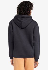 Dark navy hoodie made of soft, textured fabric. Features a large hood, ribbed cuffs, and hem. Simple design with no visible logos or patterns.