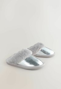 Silver metallic slippers with a soft gray faux fur strap, flat sole, and smooth texture. Front view, highlighting the shiny material and design.
