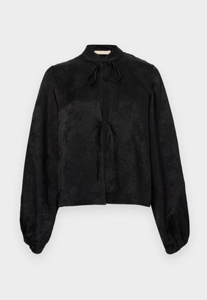 Black long-sleeve blouse with subtle floral texture, high neck, and two front tie closures, featuring voluminous sleeves gathered at the cuffs.