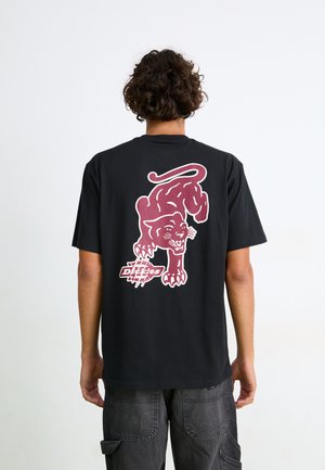 Black cotton t-shirt featuring a large maroon panther graphic on the back, short sleeves, and a relaxed fit.