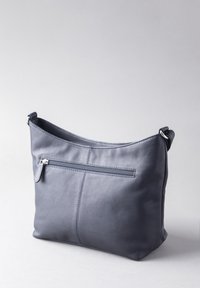 Gray leather shoulder bag with a structured, curved design. Features a zippered back pocket and minimal stitching detail. Silver hardware accents.