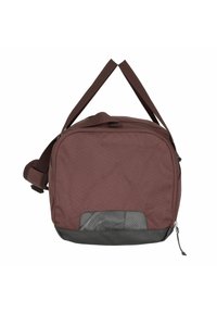 Brown fabric bag with a rectangular shape, featuring a black bottom, adjustable shoulder strap, and a mesh pocket on the front.