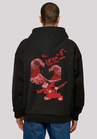 Black hoodie featuring a bold red graphic of a character with waves and a sword. Made of soft cotton blend, showcasing a relaxed fit.