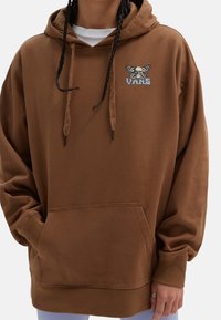 Brown hooded sweatshirt with front kangaroo pocket, ribbed cuffs and hem, featuring a skull and butterfly graphic embroidered on the chest.