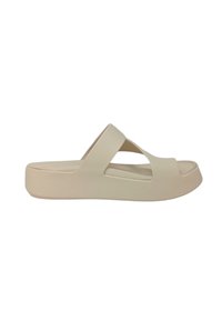 Sandali platform beige con punta aperta, cinturini incrociati, suola spessa e superficie liscia. Progettati per una facile calzata.