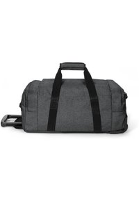 Grå tygresväska med svarta remmar, rektangulär form, slät textur och ett utdragbart handtag för enkel transport.