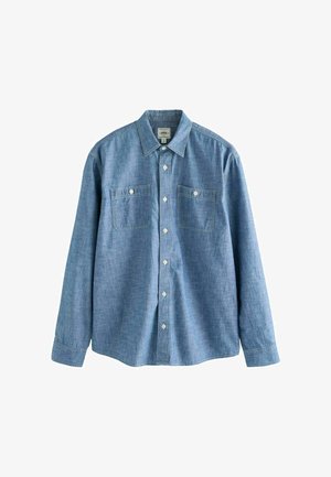 Világoskék, hosszú ujjú ing, amely denim anyagból készült, gombos gallérral, két mellzsebbel és elöl gombos záródással.