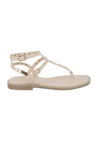 Sandali piatti color nude con cinturini incrociati, dettagli in metallico dorato e suola testurizzata. Presentano un sostegno per le dita del piede e una soletta imbottita.