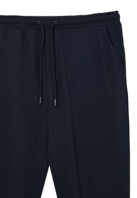 Navyblaue Jogginghosen aus strukturiertem Stoff. Mit elastischem Bund und Kordelzug, seitlichen Taschen und schmal zulaufenden Beinen.