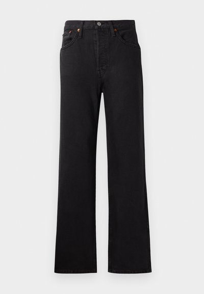 Korkeavyötäröiset mustat farkut, joissa on levenevä lahje, näkyvät tikkausompeleet, viisi taskua ja kuparinväriset varusteet.