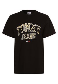 Svart bomullströja med en iögonfallande "TOMMY JEANS"-grafik i gult och vitt, med en liten röd, vit och blå accent vid fållen.