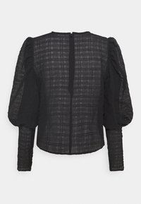 Czarna bluzka z długim rękawem, z bufiastymi rękawami, o wyrazistej teksturze w kratę i dyskretnym zamkiem błyskawicznym z tyłu. Wykonana z lekkiego materiału.