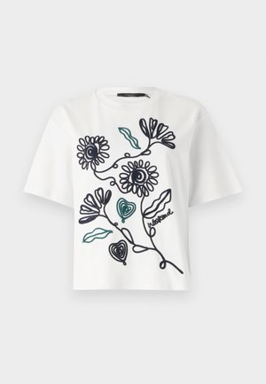 Hvid bomulds t-shirt med korte ærmer, der har sorte stregtegninger af blomster og blade, fremhævet med grøn syning.