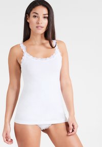 White tank top with lace accents around the neckline and straps, featuring a smooth texture and fitted design. Paired with matching white underwear.