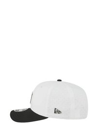White cap with black visor, featuring a structured design, mesh detailing, and embroidered logo on the side. Adjustable strap at the back.