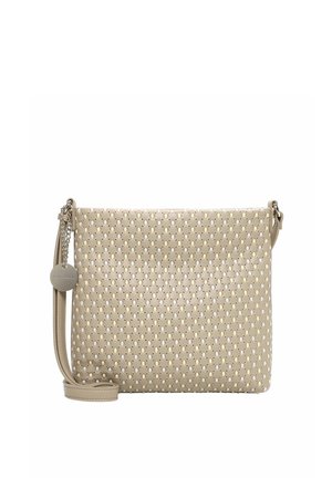 Beige crossbody bag with a perforated pattern, adjustable strap, and round metallic brand charm hanging on the side.
