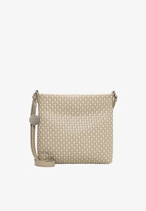Bolso bandolera beige con un patrón perforado, correa ajustable y un charm redondo metálico de la marca colgando a un lado.