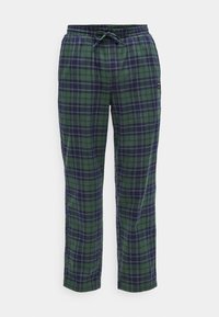 Zelené a námornícke kárované nohavice s elastickým pásom, nastaviteľnou šnúrkou a bočnou kapsou. Vyrobené z mäkkej tkaniny s voľným strihom.