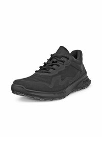 Svarta träningsskor med en texturerad mesh-övre, dämpad sula och gummiyttersula med ett vågmönster, utformade för komfort och grepp.