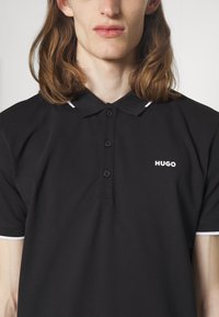HUGO DINOSO - Polo - black