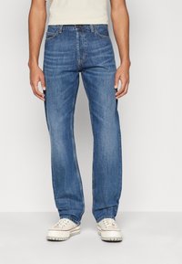 Light blue denim jeans with a straight-leg cut. Features stitching details, five pockets, and a button closure at the waistband.