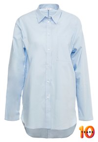 Light blue long-sleeve button-up shirt, made of cotton, featuring a collar, a front pocket, and a curved hemline.