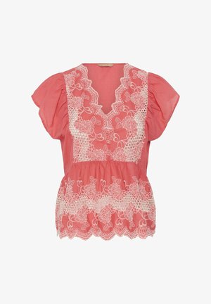 Coral pink blouse with white floral lace overlays on the front and scalloped hem, featuring short puff sleeves and a V-neckline.