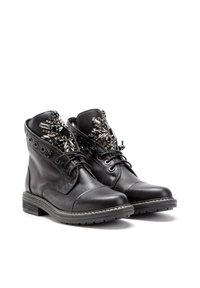 Botines negros de piel con adornos metálicos decorativos en el collar, punta redonda y un bajo tacón apilado.