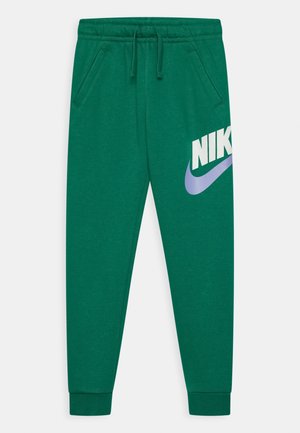 Zielone spodnie dresowe Nike z elastycznym pasem, sznurkiem, bocznymi kieszeniami, ściągaczami przy kostkach i dużym białym i fioletowym logo Nike na lewej nodze.