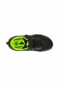 Black athletic shoe with mesh fabric, lime green accents, adjustable strap, and rubber sole. Features a breathable design and textured upper.