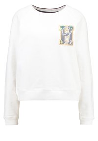 Witte sweatshirts met een ronde hals, geribde manchetten en zoom. Voorzien van een geborduurd logopatch in meerkleurige steken aan de voorkant.