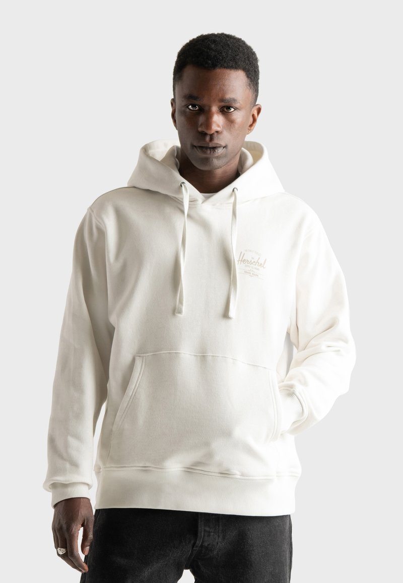 White, heavy cotton hoodie with a front pocket, drawstring hood, ribbed cuffs, and a small logo detail on the chest.