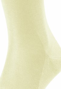 Helle gelbe Baumwollsocke mit gerippter Textur und glattem Design, in passgenauer Form und mit verstärktem Fersenbereich für den Komfort.