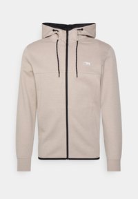 Felpa con zip colore beige chiaro, con interno e dettagli neri. Presenta tasche frontali, cappuccio regolabile e zip nera a contrasto.