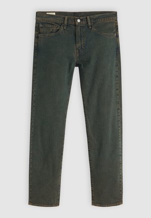 Mörkgröna slim-fit jeans med framfickor, bältesöglor och knäppning, visade liggande på en ljus bakgrund.