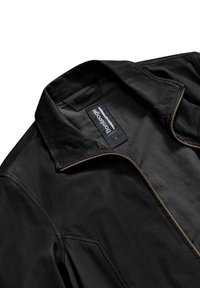 Giacca di pelle nera con colletto elegante, cuciture visibili e zip a contrasto. Etichetta con la scritta "Bambooogie," taglia L.