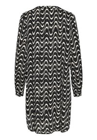 Robe noire et blanche à manches longues, avec un motif ondulé, coupe ample et col rond, fabriquée en tissu doux et léger.