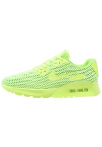 Neon green Nike Air Max sneaker with mesh upper, visible air cushion in sole, lace-up design, and swoosh logo on side.