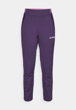 Paarse wandelpantalons met een aansluitend design, elastische tailleband, zijzakken met rits en een subtiel geometrisch patroon op de onderbenen.