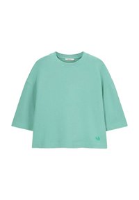 T-shirt surdimensionné vert menthe en coton doux, avec un col rond et des manches courtes, et un petit logo discret au bas.