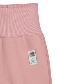 Lichtroze katoenen joggingbroek met een geribde tailleband en een gestikte label met de tekst "klaar voor avontuur" in donkerblauw aan de linkerkant.