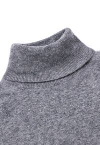 Collo e parte superiore del petto di un maglione grigio a coste con collo alto, in morbido tessuto lavorato con una texture visibile su sfondo bianco.