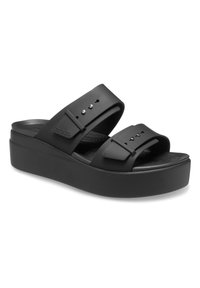 Black platform sandals featuring two wide straps with adjustable buckles, made of flexible material with a textured footbed for comfort.