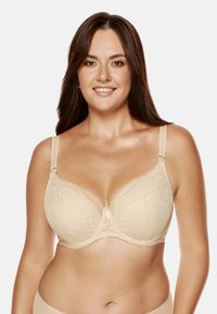 Beżowy biustonosz koronkowy z kwiatowymi wzorami, wsparcie stanikowe, regulowane ramiączka oraz kokardka z przodu. Gładka faktura.