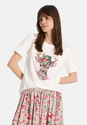 White short-sleeve t-shirt featuring a deer illustration wearing a floral hat, paired with a floral patterned skirt in muted colors.