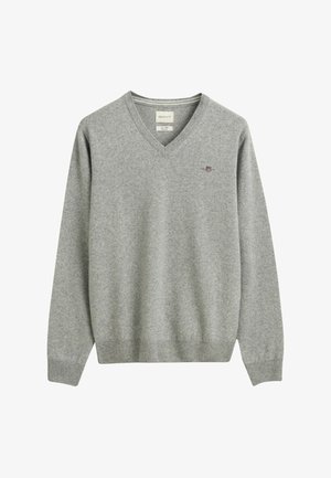 Gray v-neck sweater in soft fabric, featuring ribbed cuffs and hem, with a small, intricate logo embroidered on the chest.