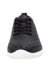 Black sneaker featuring a textured upper with geometric perforations, flat black laces, and a white EVA sole.